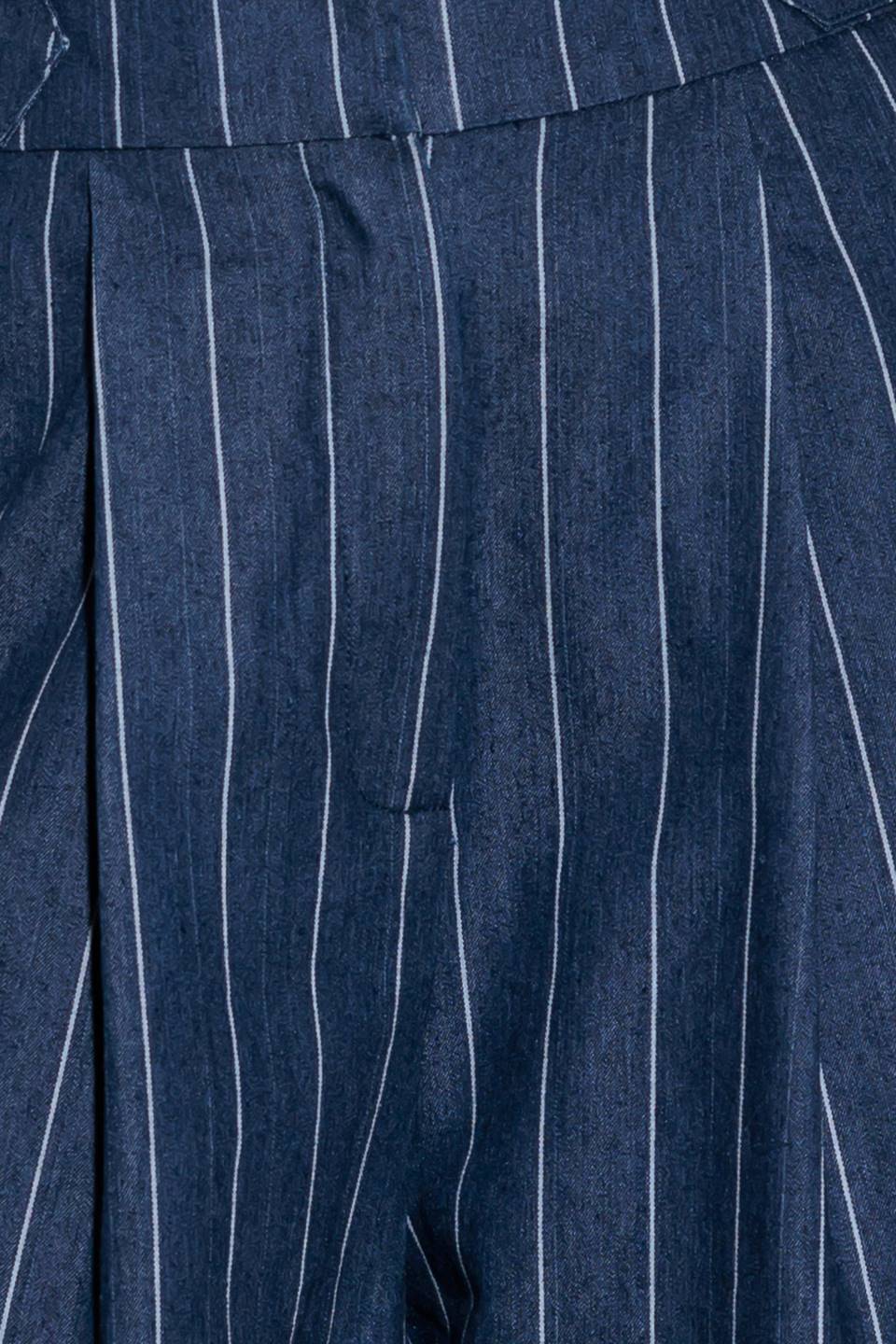 A striped woven pant featuring front closure, side tab, pockets and wide leg.