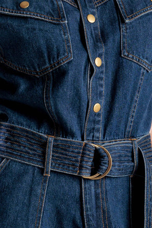 A denim romper featuring a round neckline, button down, cuffed sleeve, self belt, and pockets.