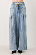 Light blue wide-leg denim pants with pleated front panels, side pockets, and a cream drawstring waist, shown on a model | FREEMARKET