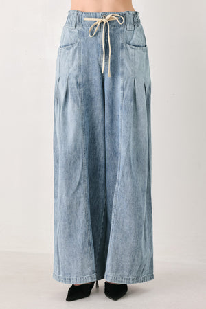 Light blue wide-leg denim pants with pleated front panels, side pockets, and a cream drawstring waist, shown on a model | FREEMARKET