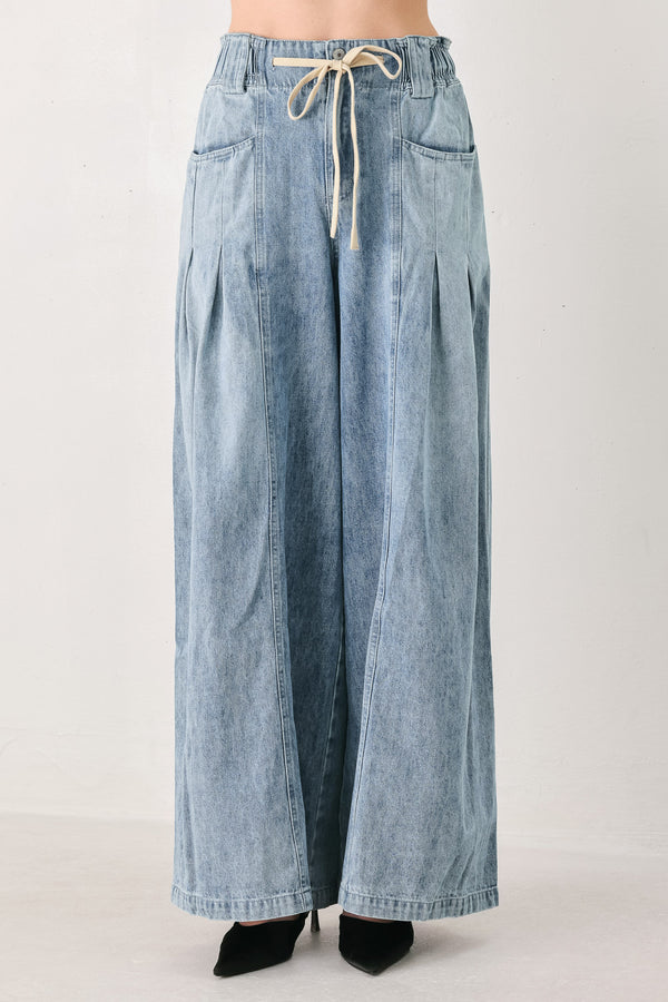 Light blue wide-leg denim pants with pleated front panels, side pockets, and a cream drawstring waist, shown on a model | FREEMARKET