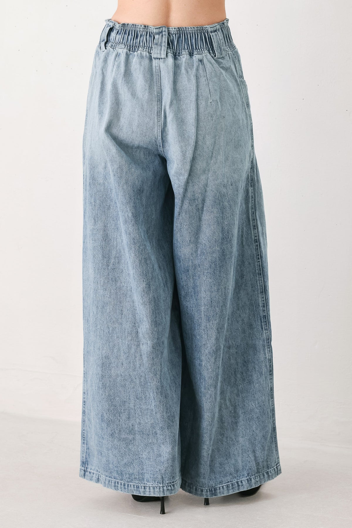 Light blue wide-leg denim pants with pleated front panels, side pockets, and a cream drawstring waist, shown on a model | FREEMARKET