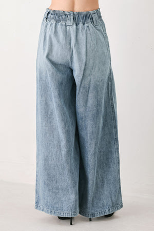 Light blue wide-leg denim pants with pleated front panels, side pockets, and a cream drawstring waist, shown on a model | FREEMARKET