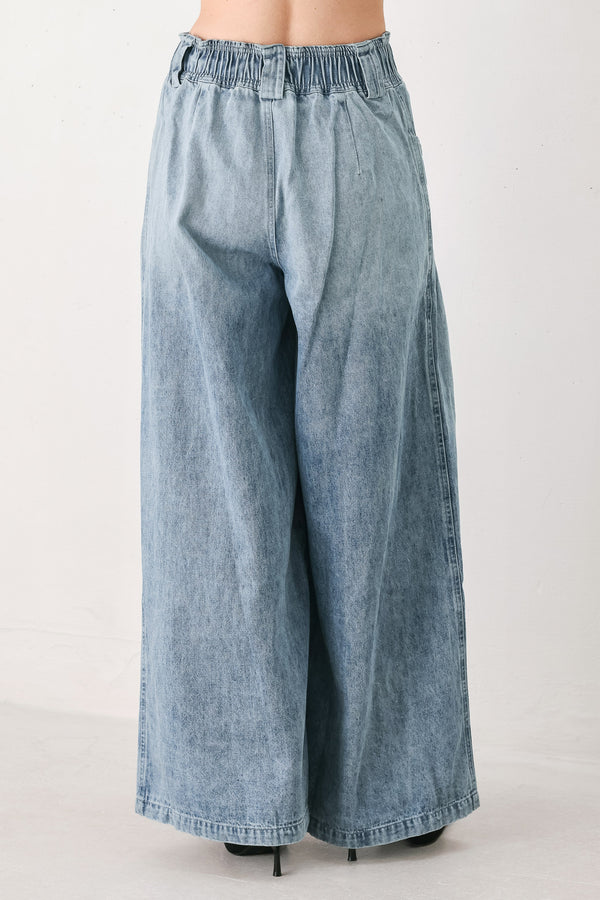 Light blue wide-leg denim pants with pleated front panels, side pockets, and a cream drawstring waist, shown on a model | FREEMARKET