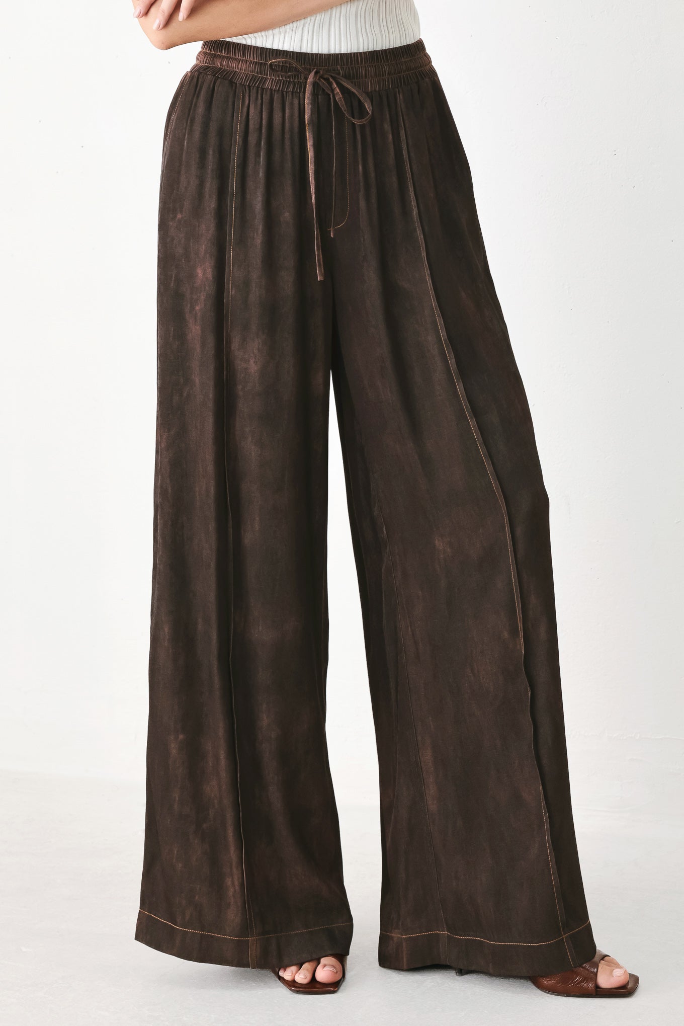 A woman wearing dark brown wide-leg drawstring pants with a mottled or washed texture | FREEMARKET