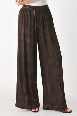 A woman wearing dark brown wide-leg drawstring pants with a mottled or washed texture | FREEMARKET