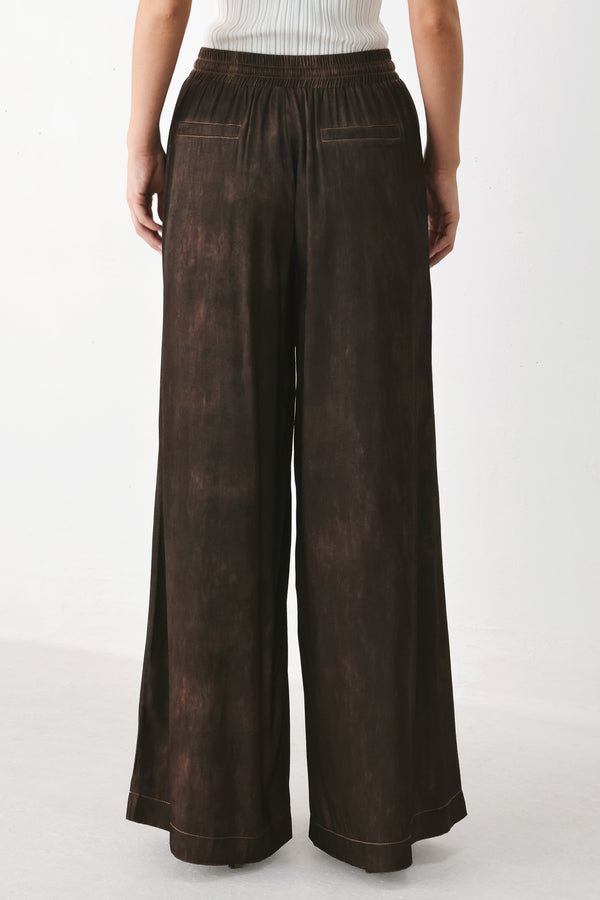 A woman wearing dark brown wide-leg drawstring pants with a mottled or washed texture | FREEMARKET