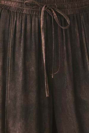 A woman wearing dark brown wide-leg drawstring pants with a mottled or washed texture | FREEMARKET