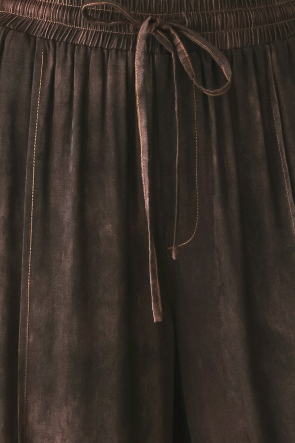 A woman wearing dark brown wide-leg drawstring pants with a mottled or washed texture | FREEMARKET