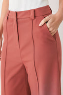 Woman wearing pink mauve woven wide-leg  trouser pants with front closure, side pockets | FREEMARKET