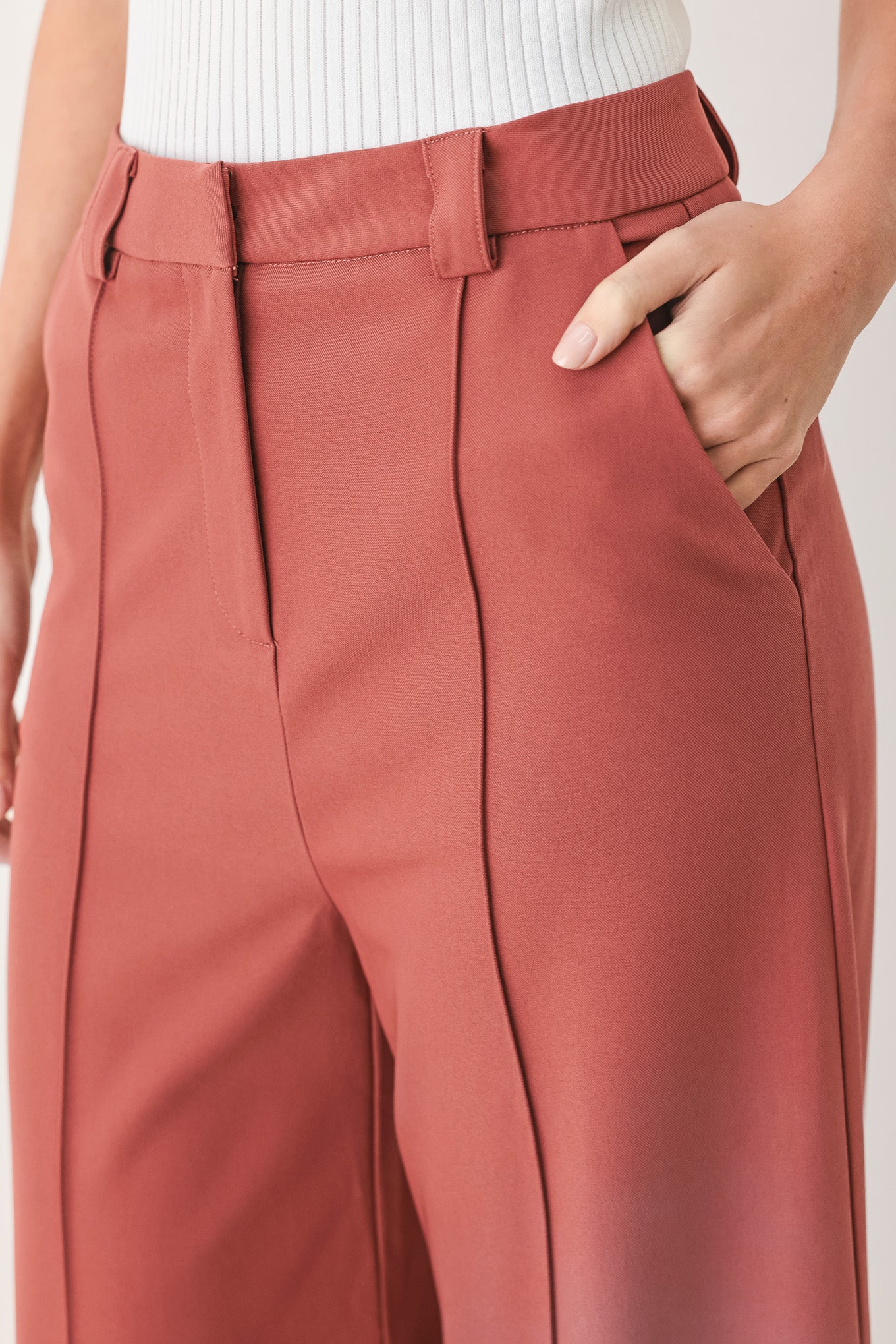 Woman wearing pink mauve woven wide-leg  trouser pants with front closure, side pockets | FREEMARKET