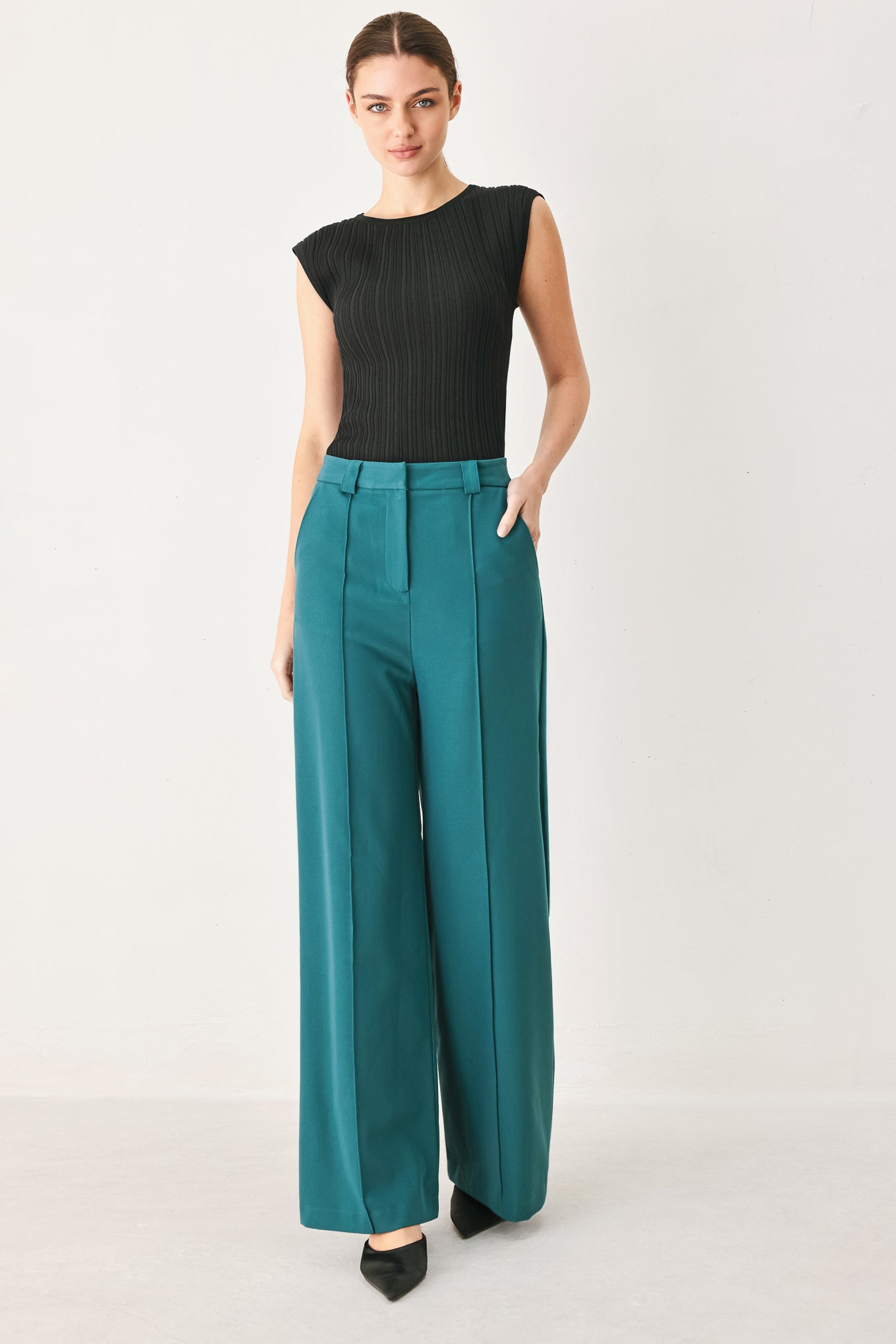 Woman wearing teal woven wide-leg  trouser pants with front closure, side pockets | FREEMARKET