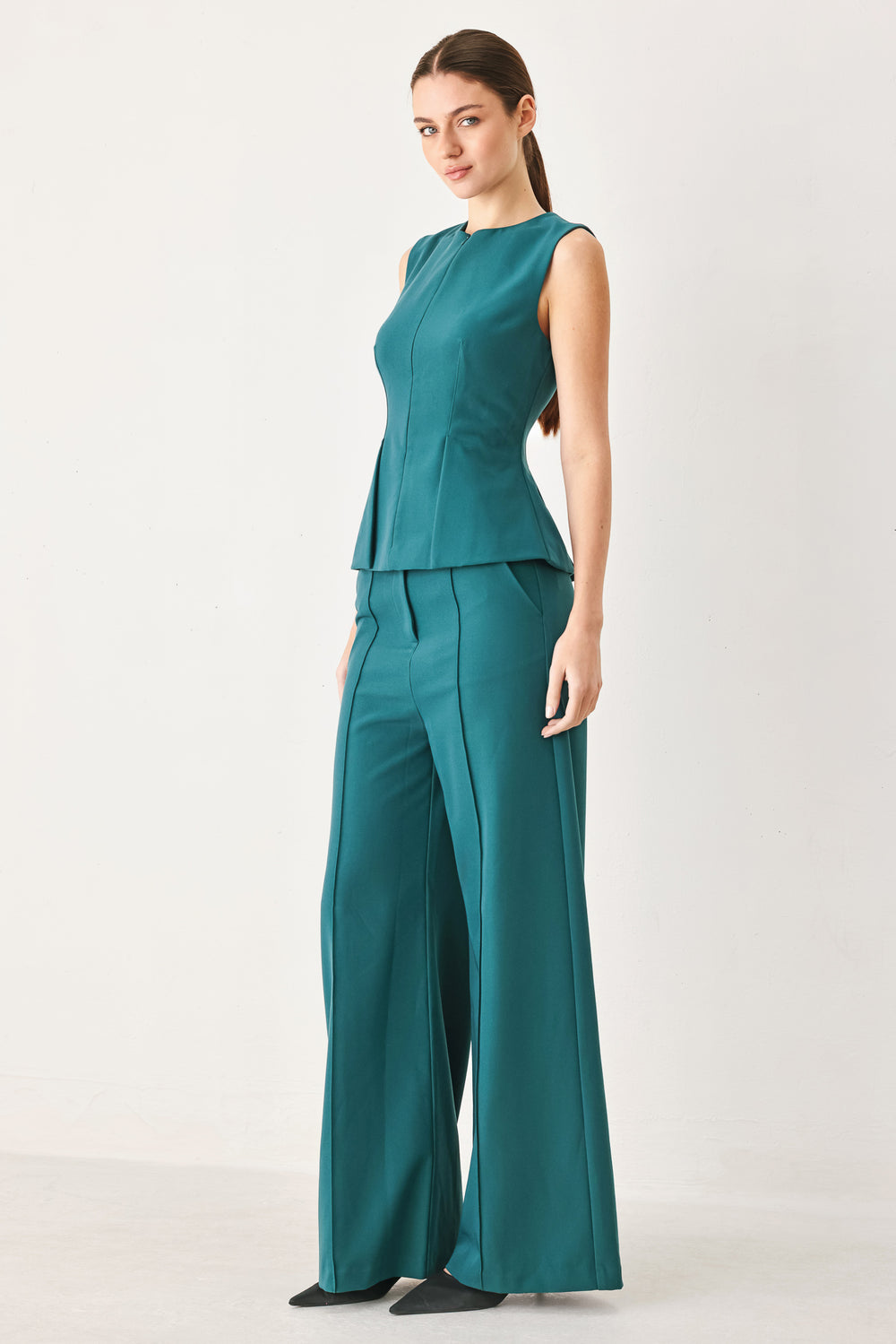 Woman wearing teal woven wide-leg  trouser pants with front closure, side pockets | FREEMARKET