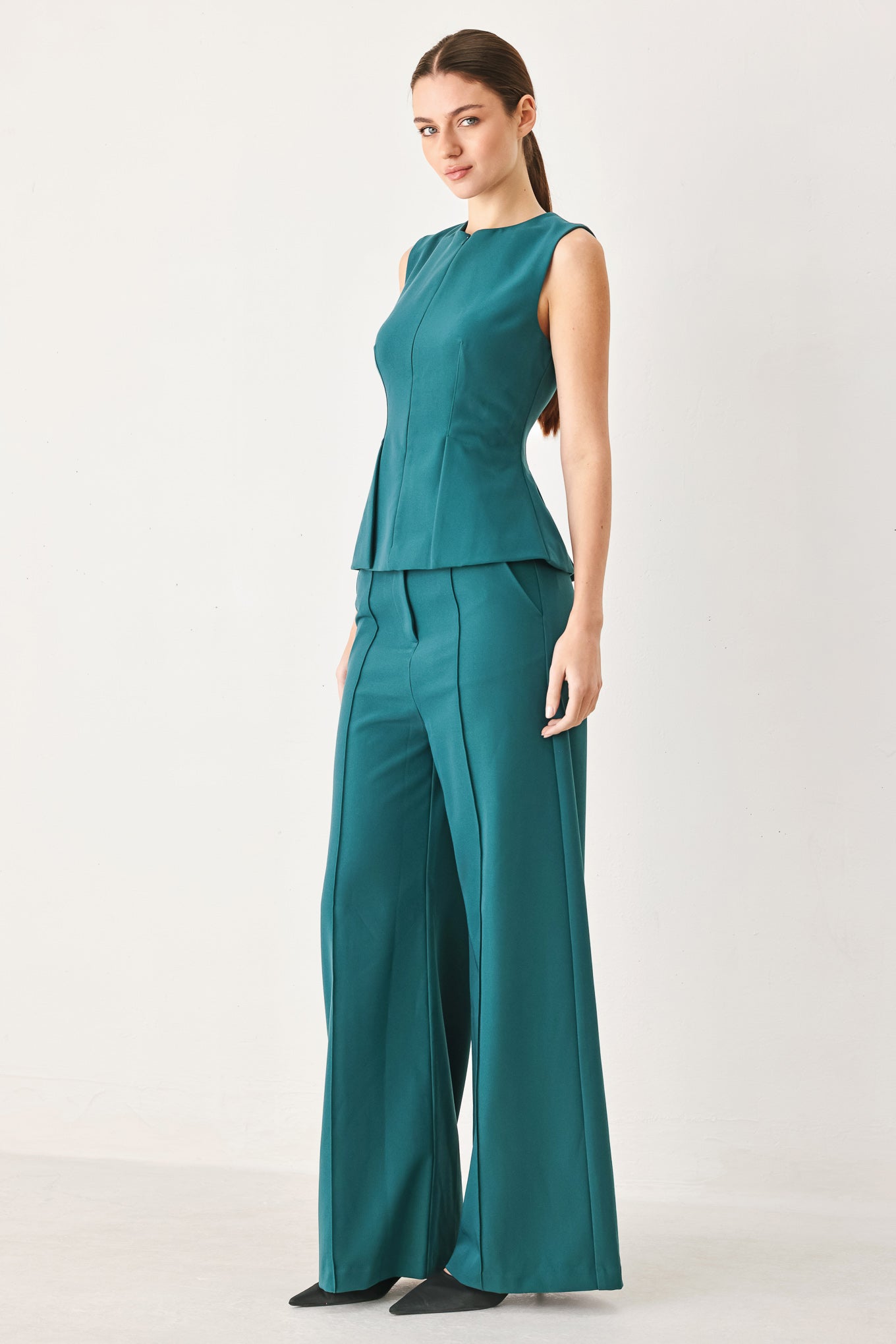 Woman wearing teal woven wide-leg  trouser pants with front closure, side pockets | FREEMARKET