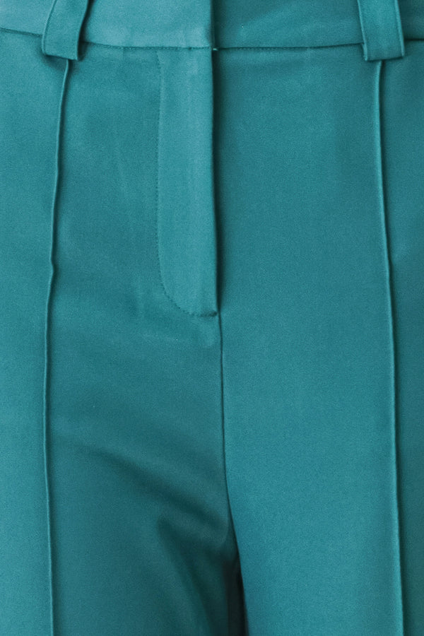 Woman wearing teal woven wide-leg  trouser pants with front closure, side pockets | FREEMARKET