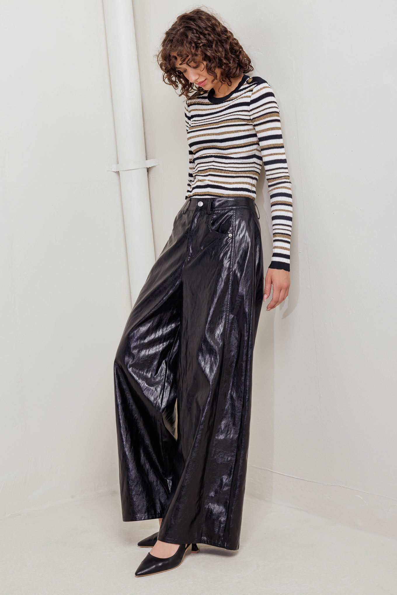 A faux leather pant with front closure, side/back pocket and wide leg