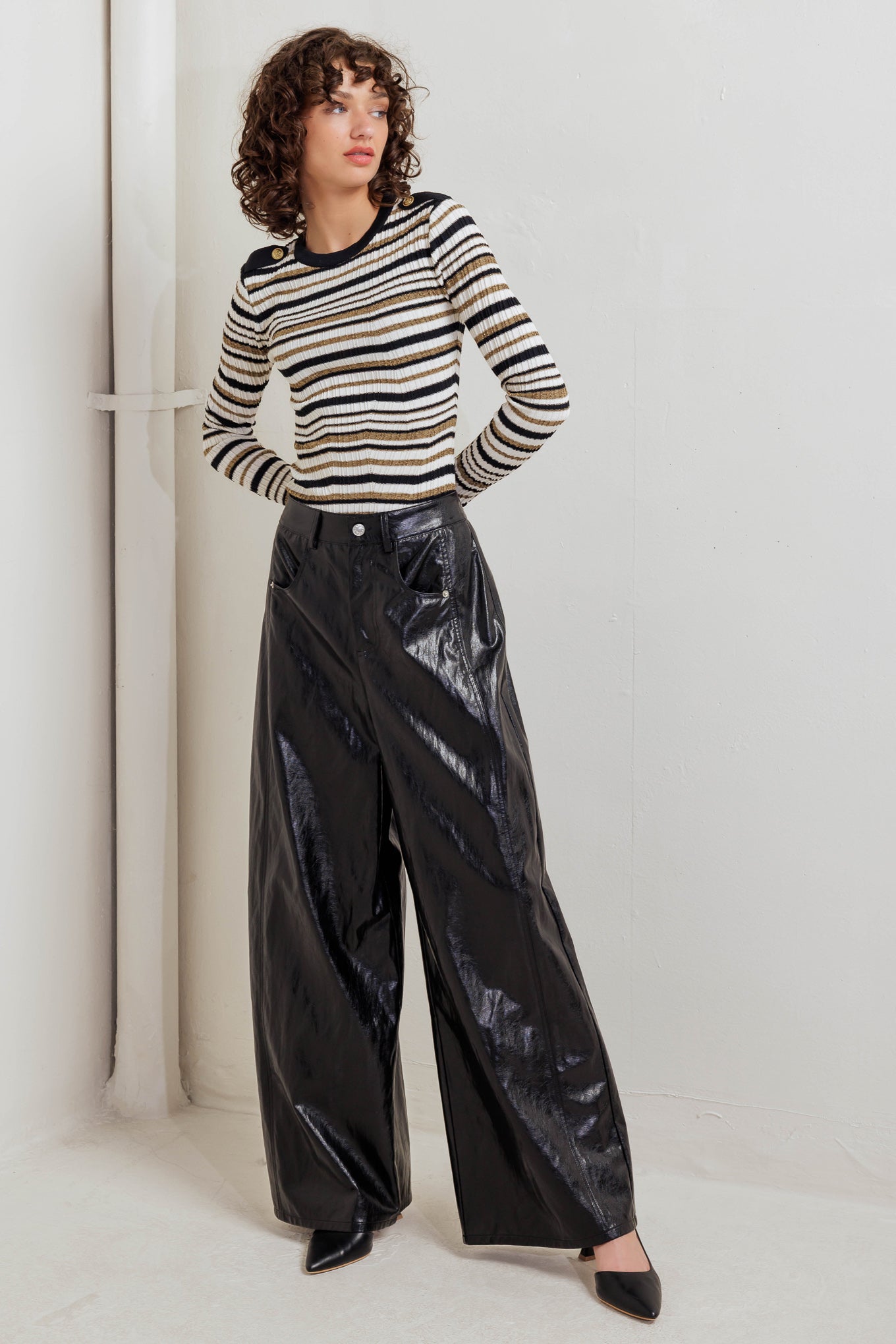 A faux leather pant with front closure, side/back pocket and wide leg