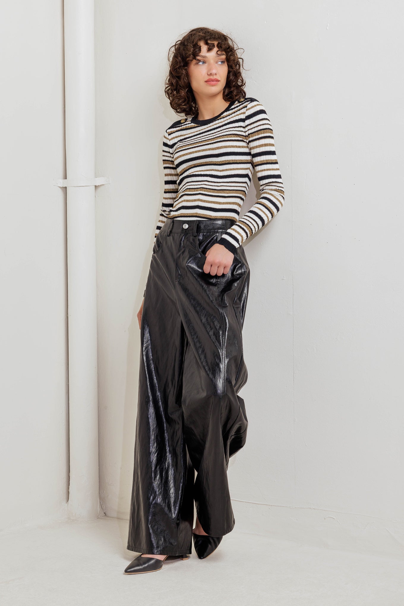 A faux leather pant with front closure, side/back pocket and wide leg
