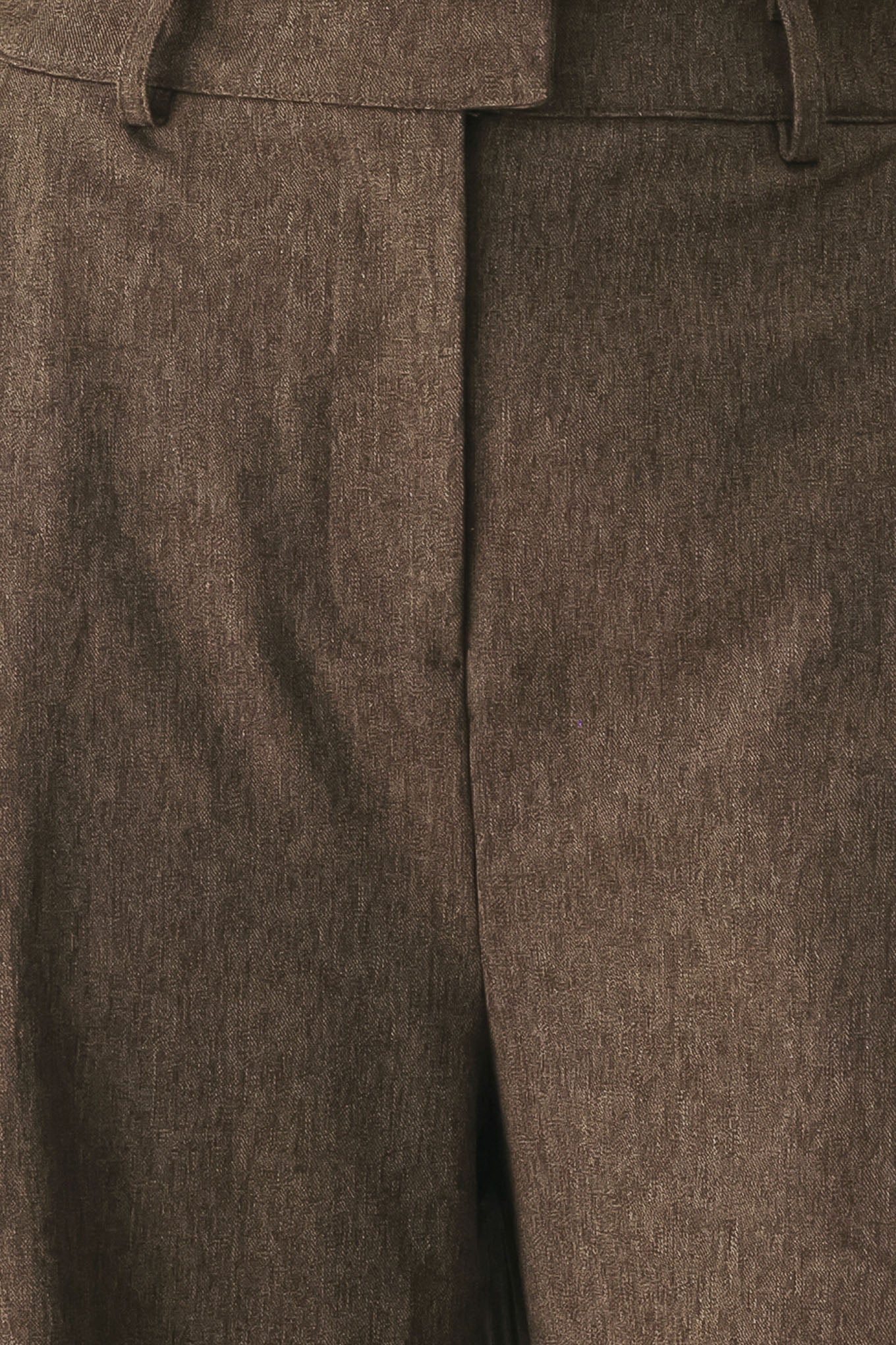 A woman wearing high-waisted, wide-leg brown trousers | FREEMARKET