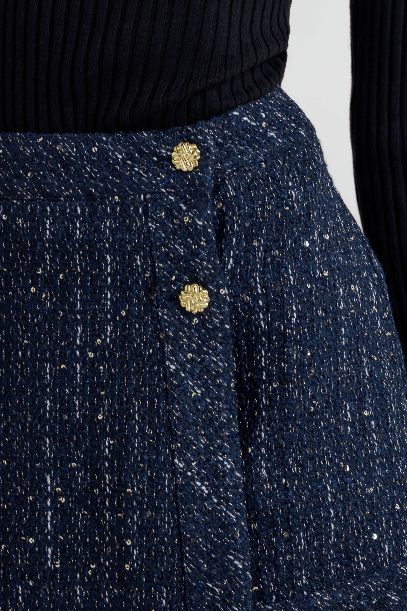A tweed skort with front button and zipper closure. 
