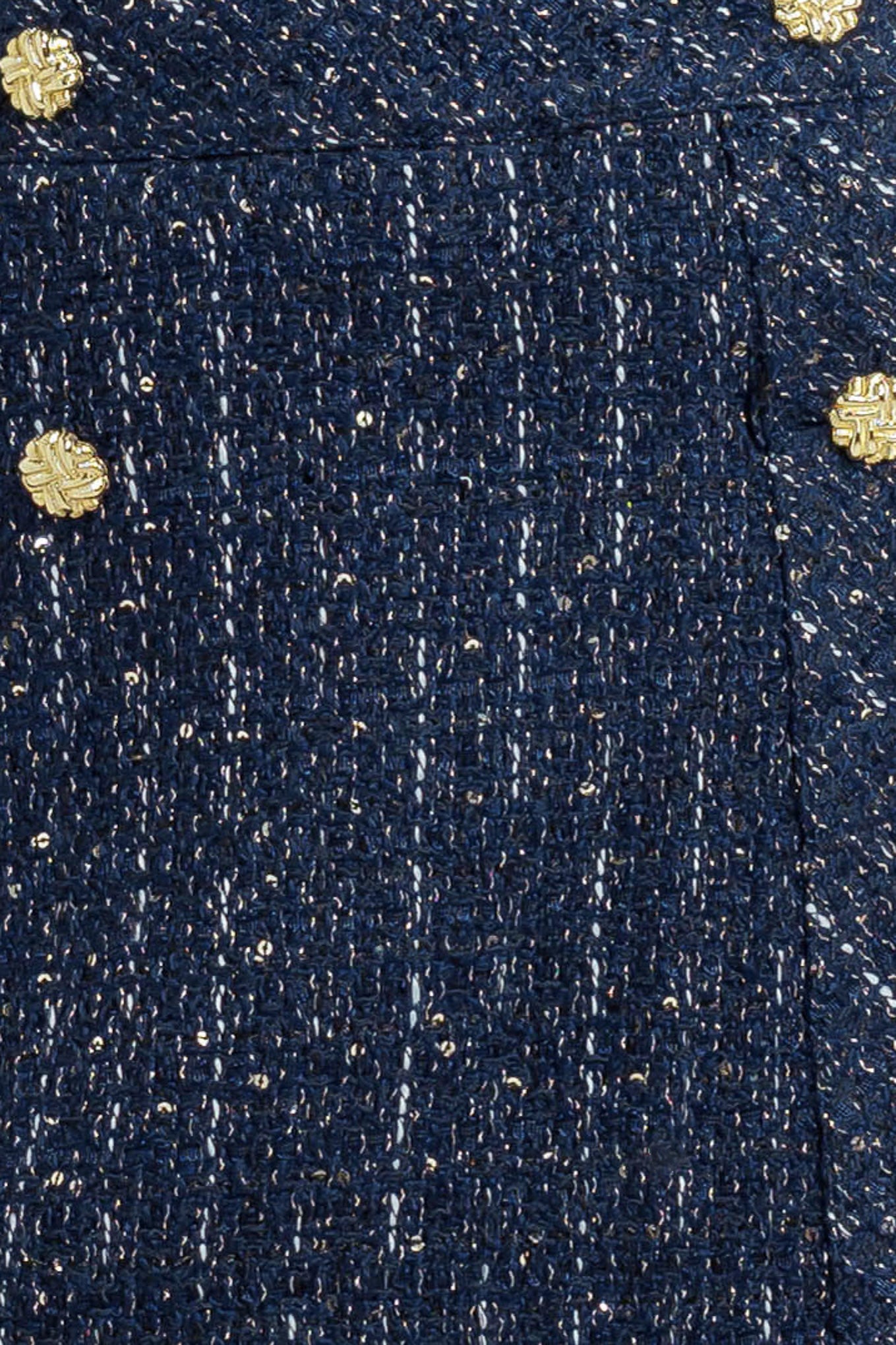 A tweed skort with front button and zipper closure. 