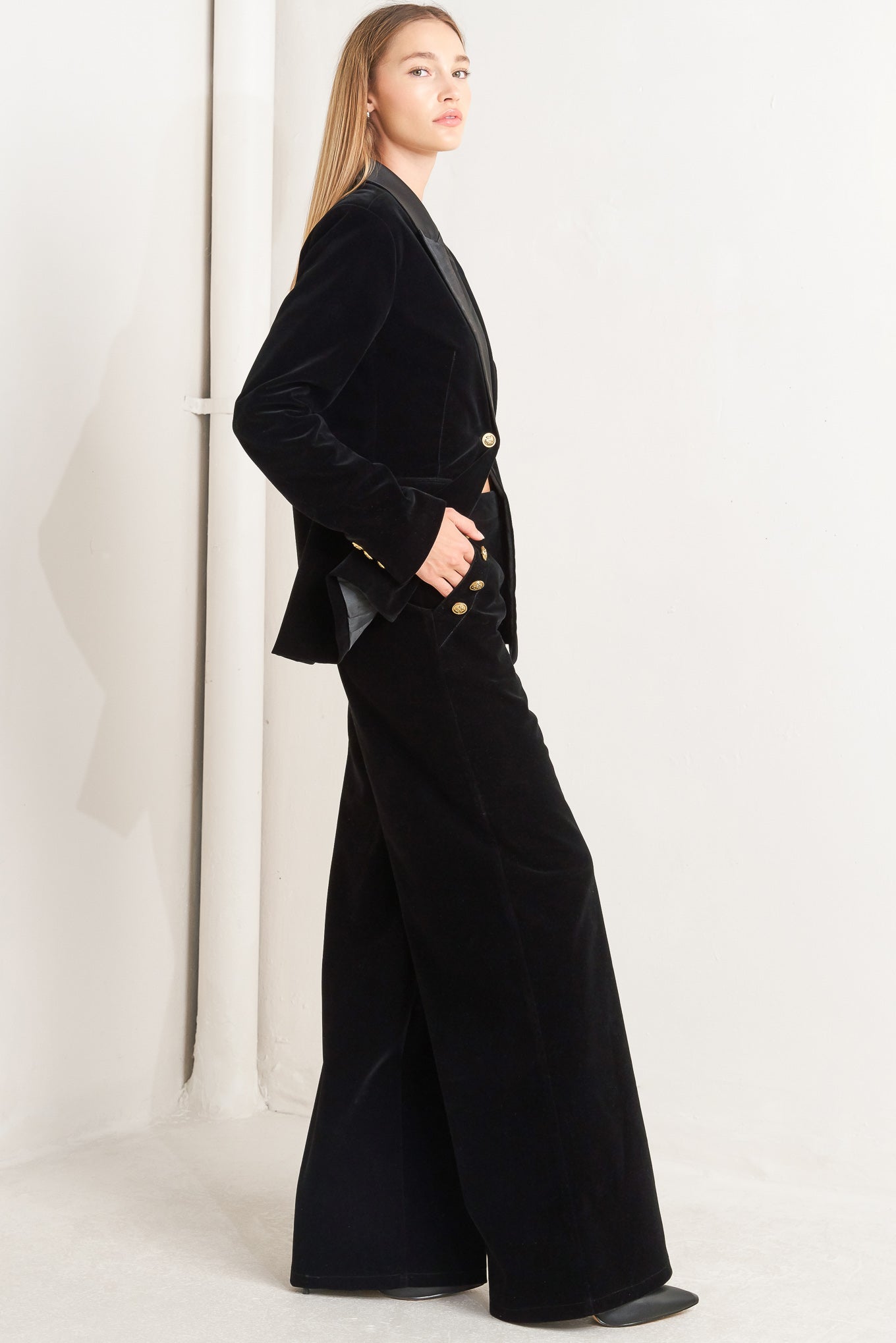 A bonded velvet pant featuring front closure, side pocket with button detail and wide leg