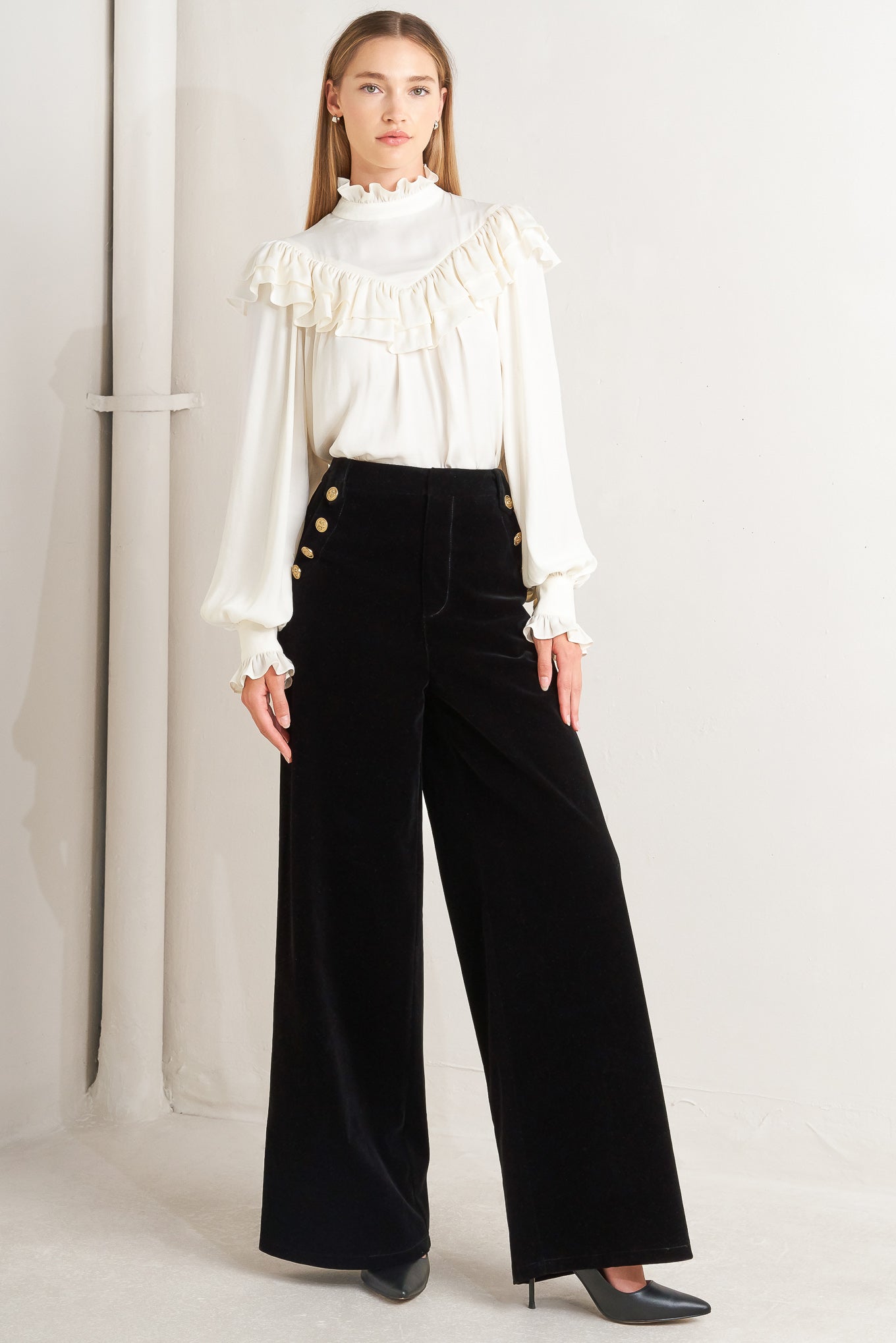 A bonded velvet pant featuring front closure, side pocket with button detail and wide leg