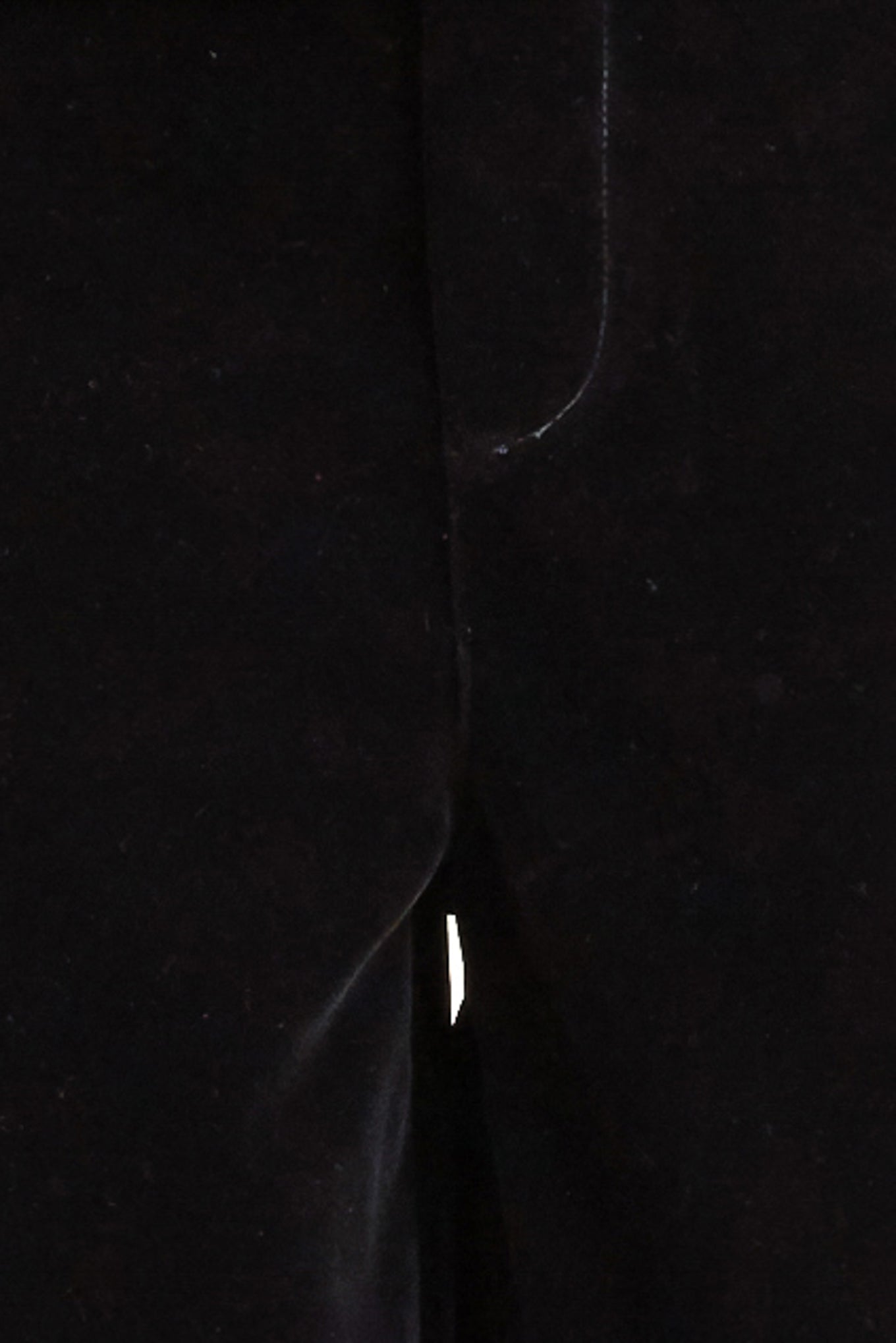 A bonded velvet pant featuring front closure, side pocket with button detail and wide leg