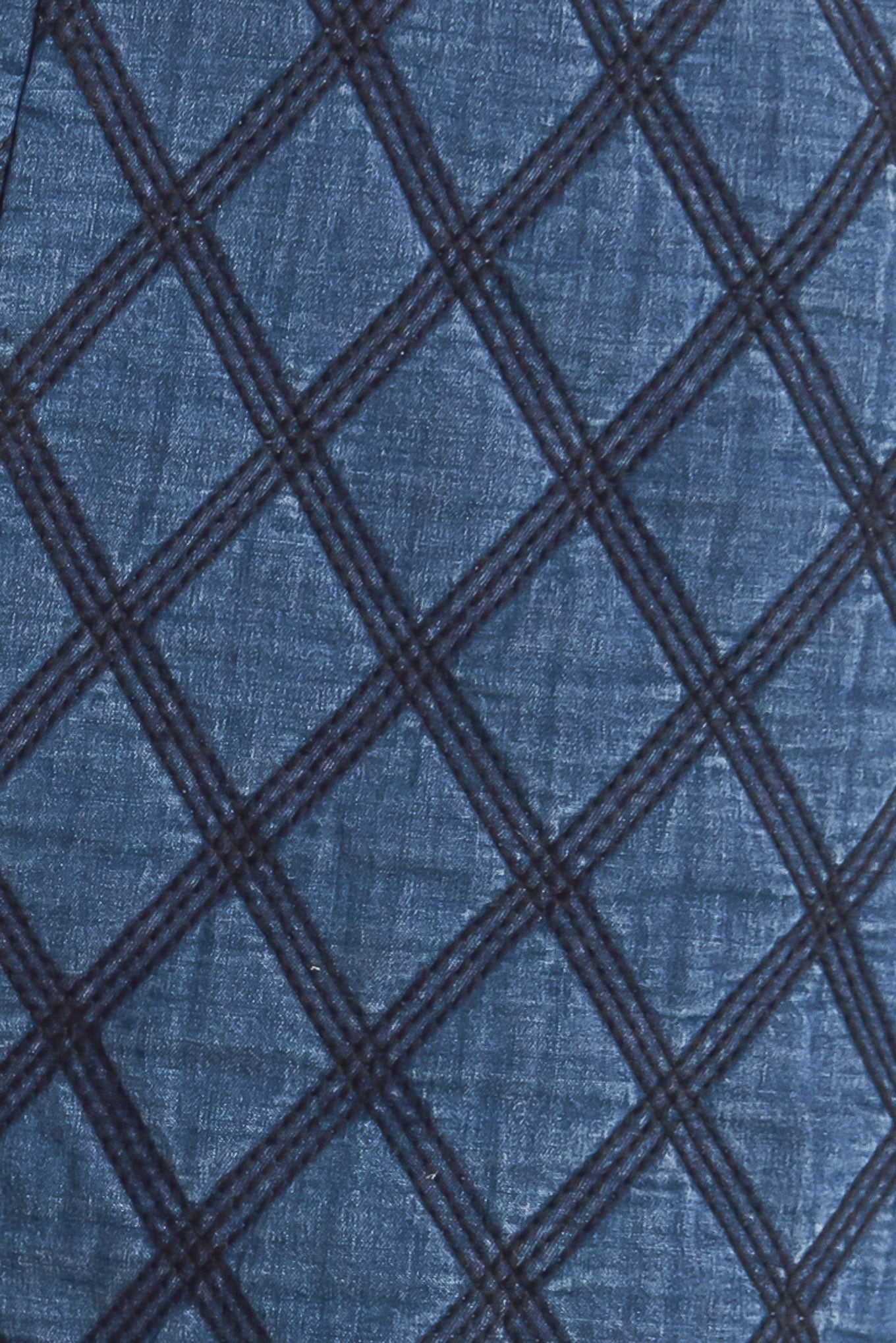 A quilted woven short featuring side pocket with button detail and back zipper closure.