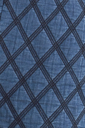 A quilted woven short featuring side pocket with button detail and back zipper closure.