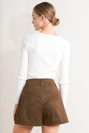 A faux suede skort with front button detail and back zipper closure.