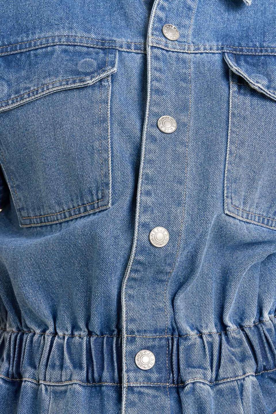 Woman wearing a denim jumpsuit against a plain background - FLYING TOMATO