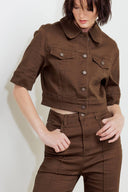 Woman wearing solid burgundy twill pants featuring front closure, front seam in the middle of each leg and pockets | FREEMARKET