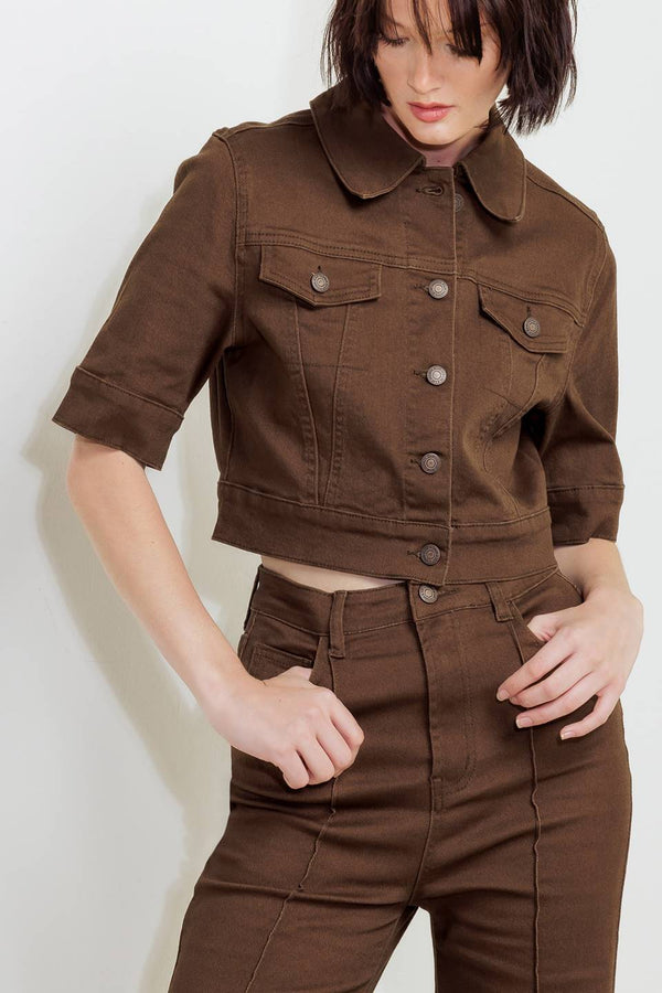 Woman wearing solid burgundy twill pants featuring front closure, front seam in the middle of each leg and pockets | FREEMARKET