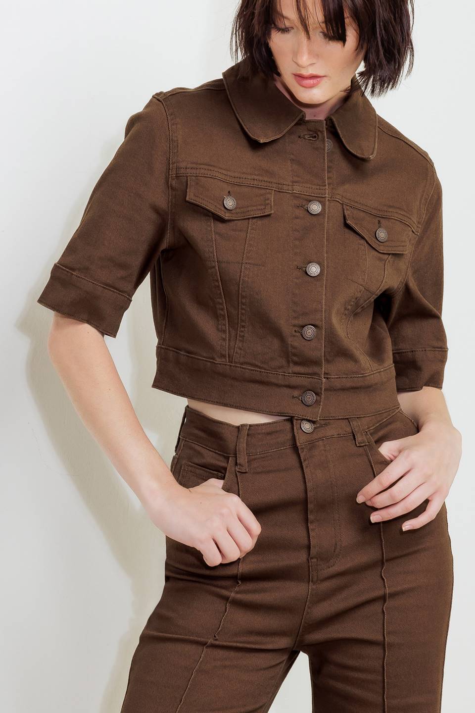 Woman wearing solid burgundy twill pants featuring front closure, front seam in the middle of each leg and pockets | FREEMARKET