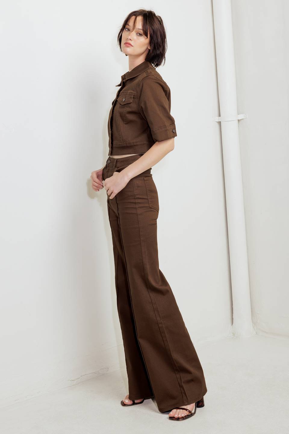 Woman wearing solid burgundy twill pants featuring front closure, front seam in the middle of each leg and pockets | FREEMARKET