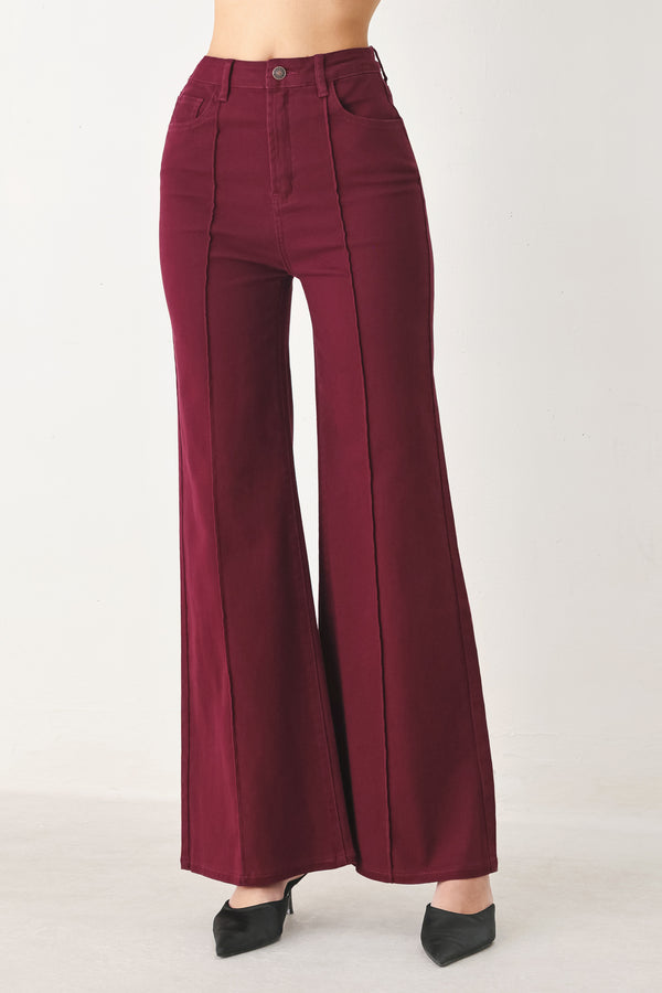Woman wearing solid burgundy twill pants featuring front closure, front seam in the middle of each leg and pockets | FREEMARKET