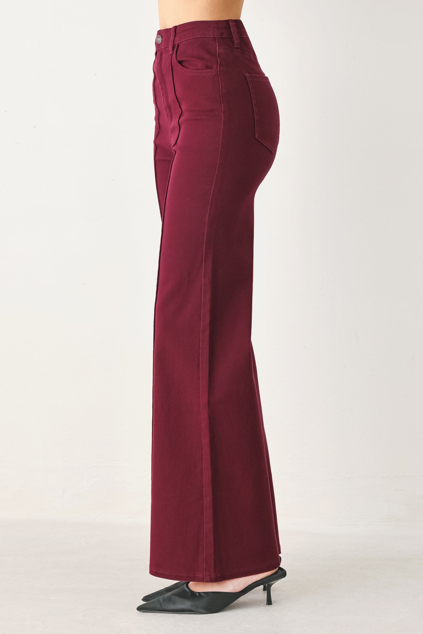 Woman wearing solid burgundy twill pants featuring front closure, front seam in the middle of each leg and pockets | FREEMARKET