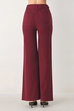 Woman wearing solid burgundy twill pants featuring front closure, front seam in the middle of each leg and pockets | FREEMARKET