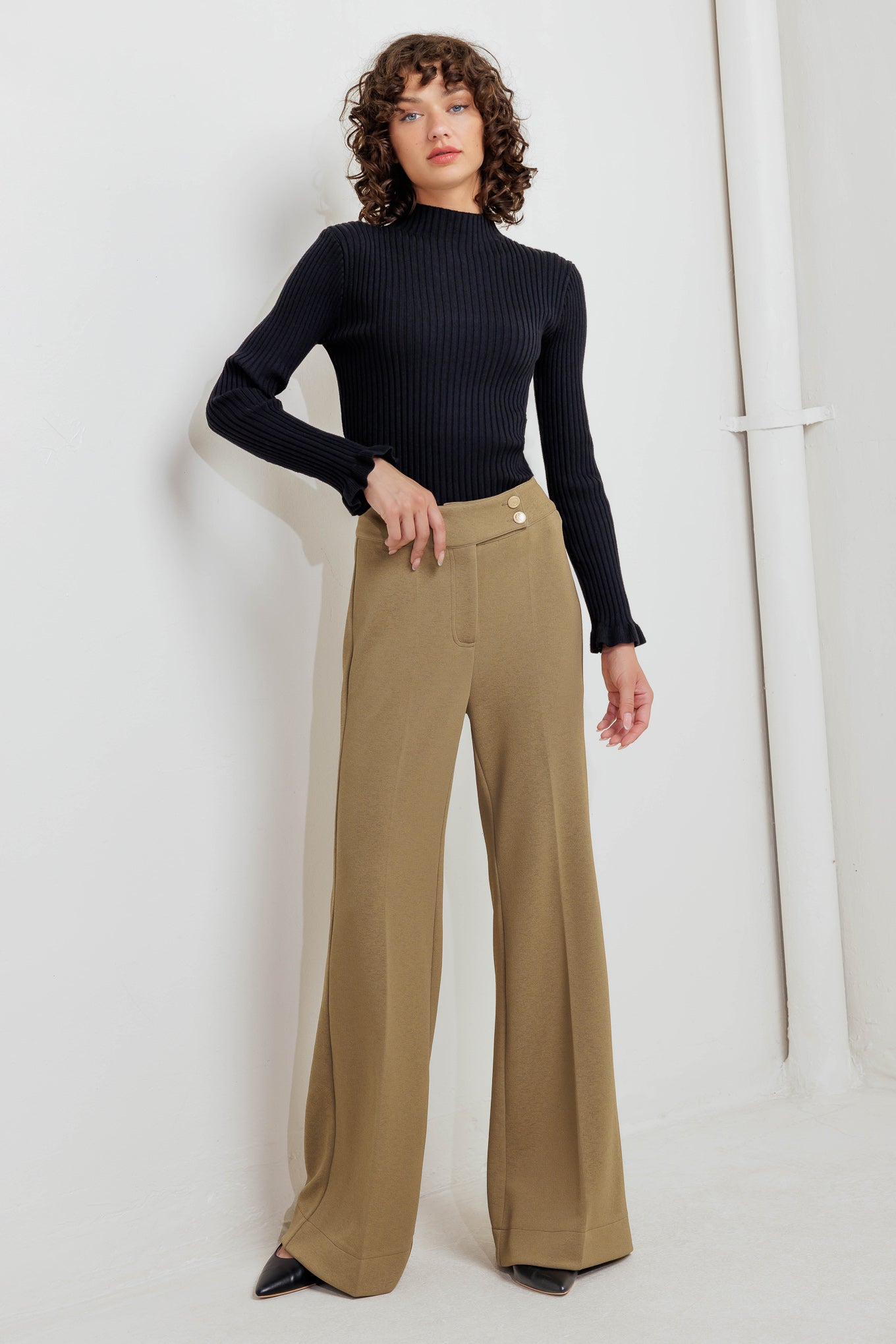 A knit pant featuring front closure and wide leg. Matching vest FJ1304
