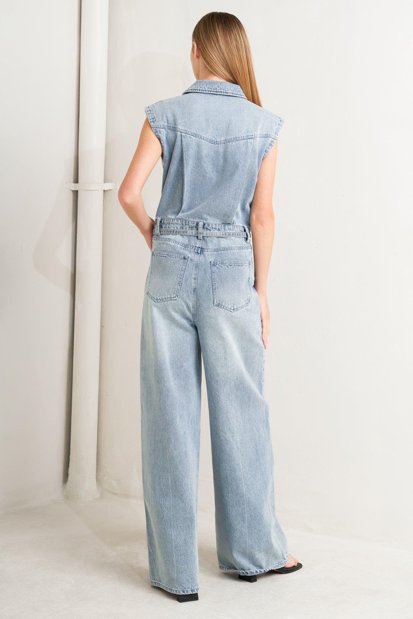 
A washed denim jumpsuit featuring collar, hidden button down and zipper closure, cap sleeve, pockets, self tie and wide leg

Details:

Self : 90% Cotton 10% Polyester

Size &amp; Fit

- Model is 5`8" And Wearing Size Small
- Measurements Taken From Size Small
- Approx. Length: 62"