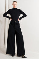 A woven pant with front closure and wide leg.