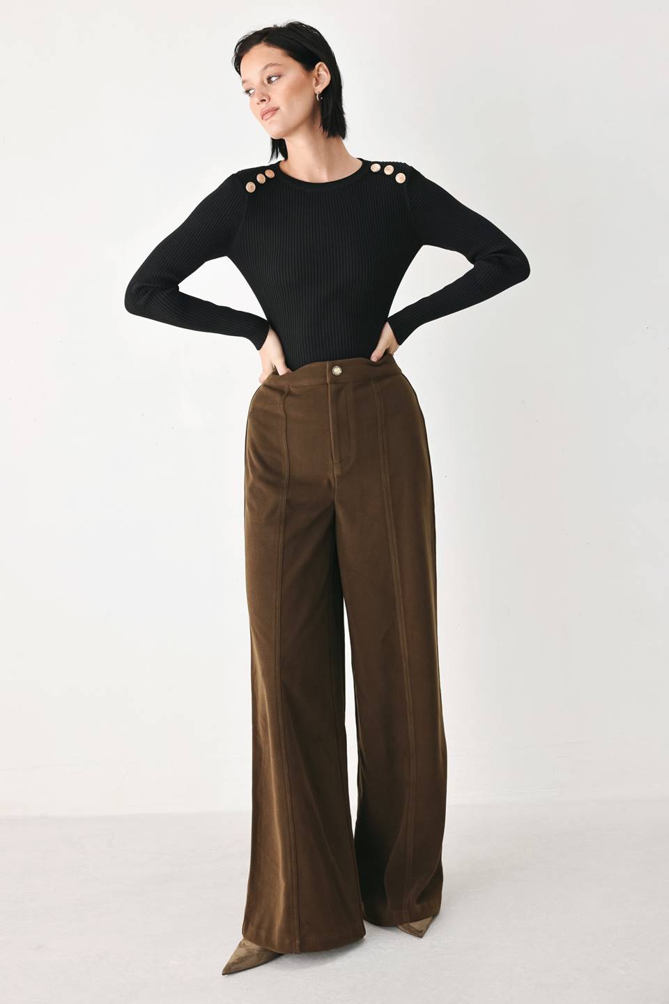 A model wearing high-waisted, wide-leg brown trousers with a corduroy-like texture | FREEMARKET