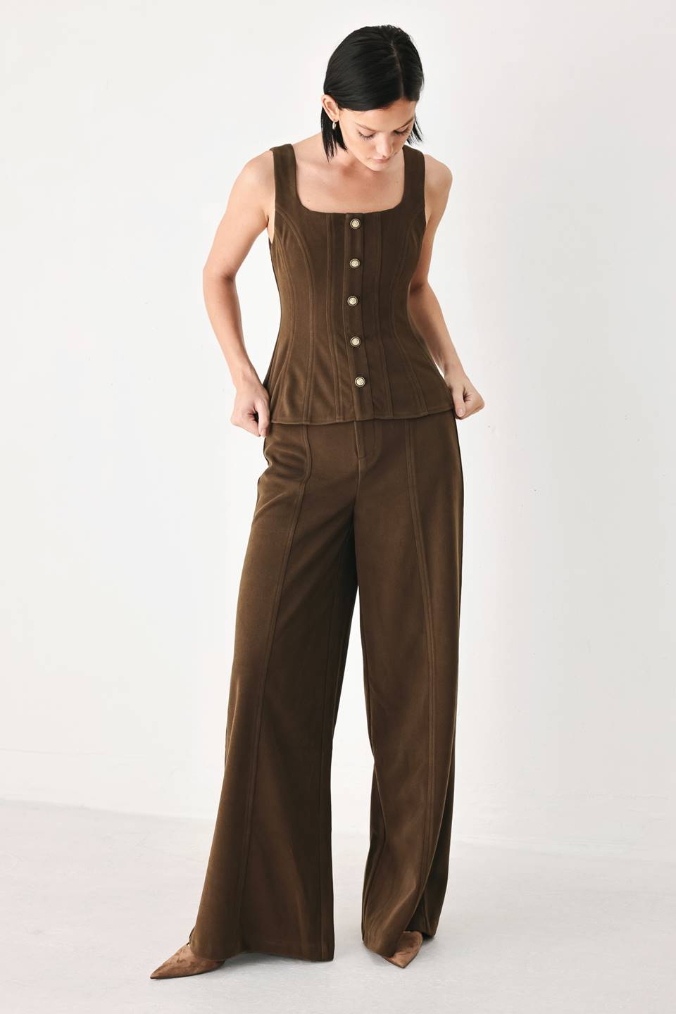 A model wearing high-waisted, wide-leg brown trousers with a corduroy-like texture | FREEMARKET