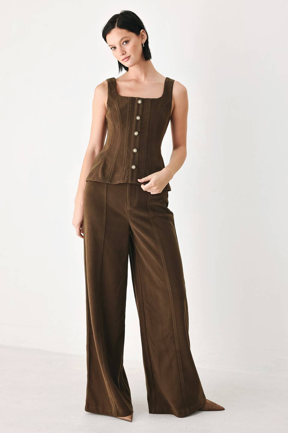 A model wearing high-waisted, wide-leg brown trousers with a corduroy-like texture | FREEMARKET