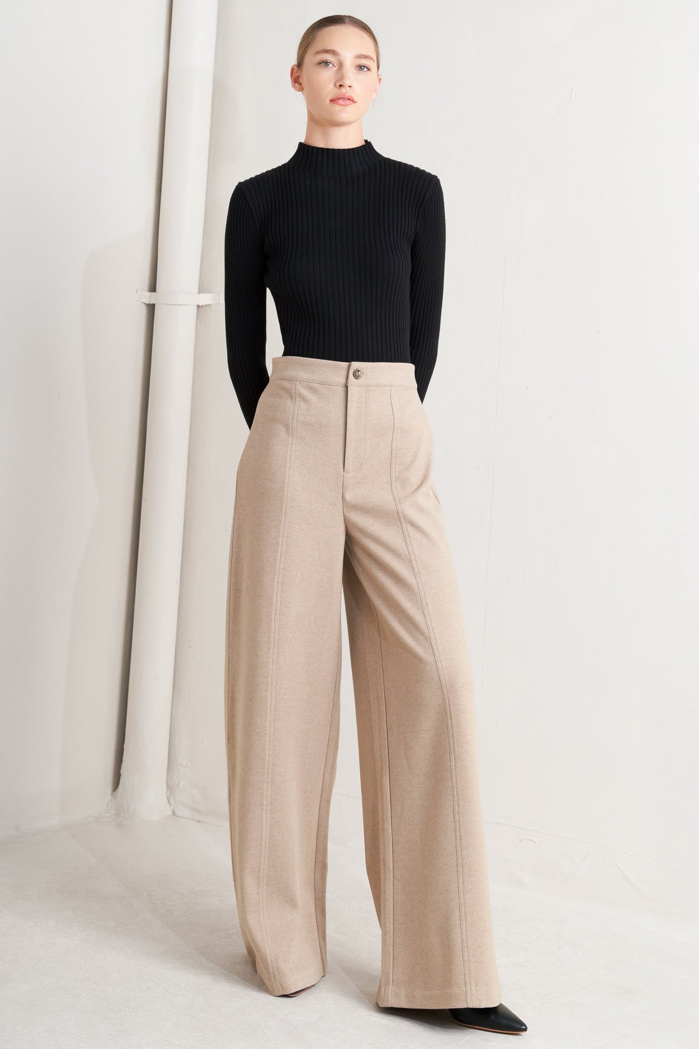 A solid knit pant with front closure and wide leg