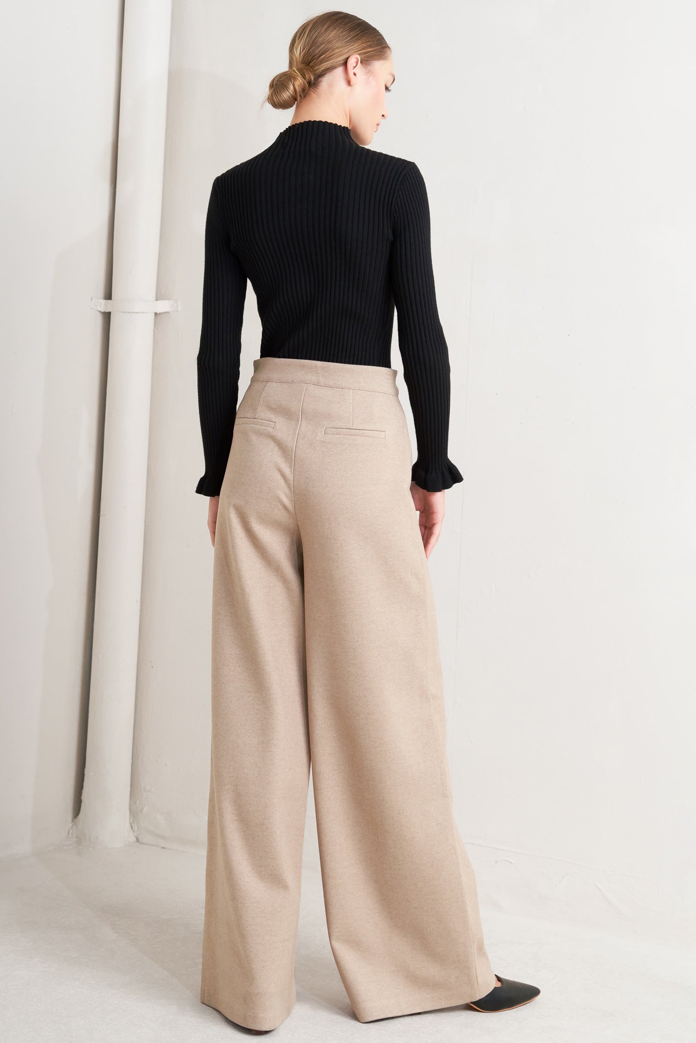 A solid knit pant with front closure and wide leg