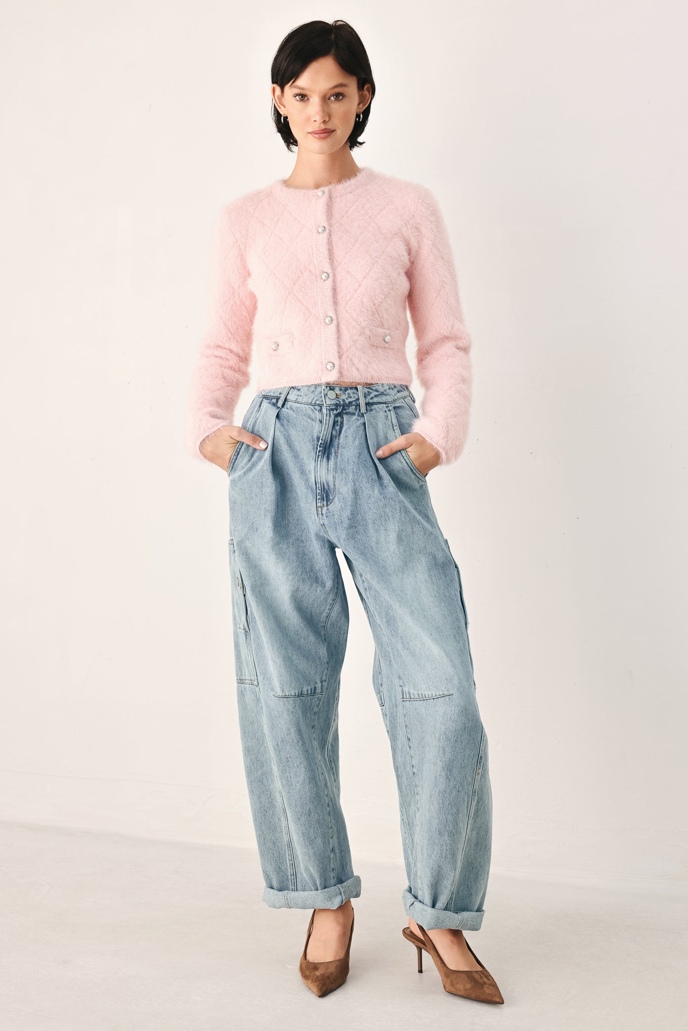A person wearing light-wash blue denim jeans with a high waist, pleated front, and wide legs | FREEMARKET
