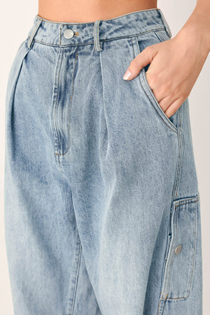A person wearing light-wash blue denim jeans with a high waist, pleated front, and wide legs | FREEMARKET