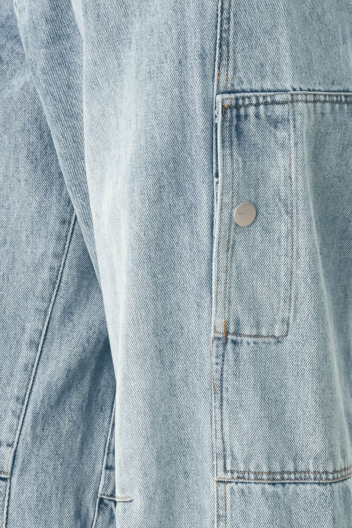 A person wearing light-wash blue denim jeans with a high waist, pleated front, and wide legs | FREEMARKET